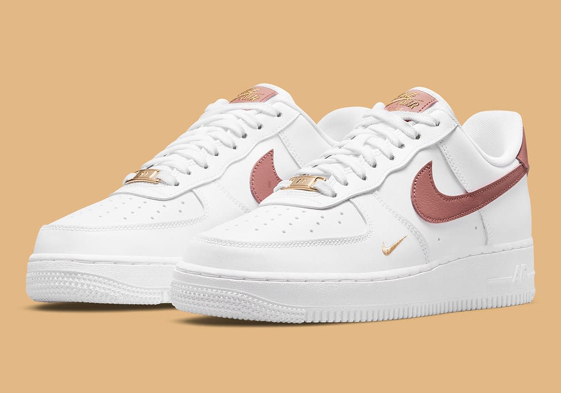 Rust pink appears on the nike air force 1 low with golden mini swooshes Clearance